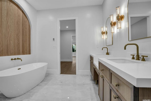 bathroom featuring vanity and a tub to relax in