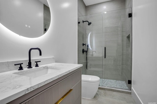 bathroom featuring vanity, an enclosed shower, and toilet