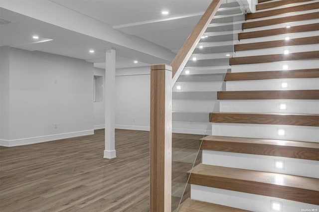 stairs featuring wood-type flooring