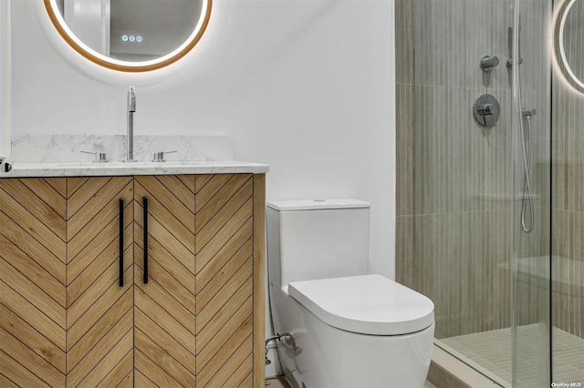 bathroom featuring vanity, toilet, and an enclosed shower