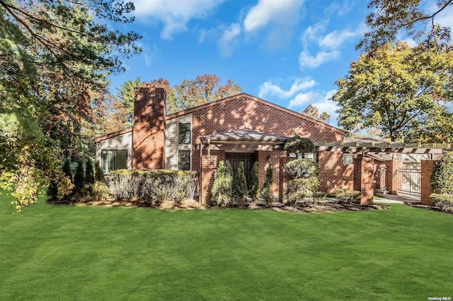 back of house featuring a pergola and a yard