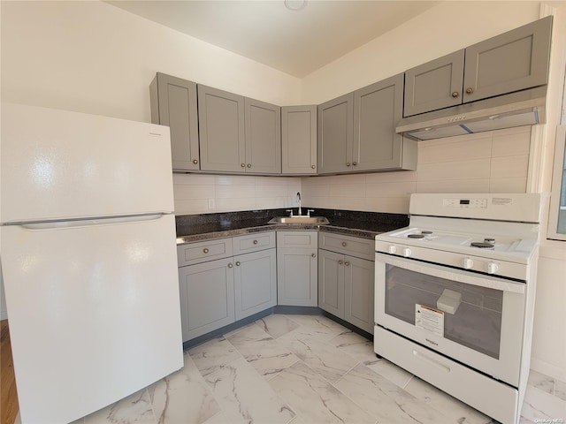 kitchen featuring white appliances, gray cabinets, a sink, under cabinet range hood, and marble finish floor