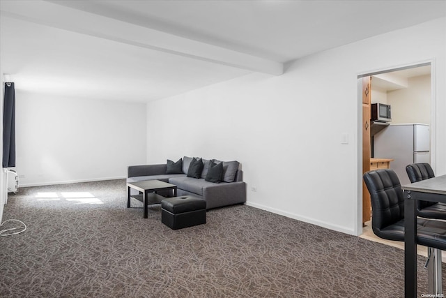 carpeted living room with beamed ceiling