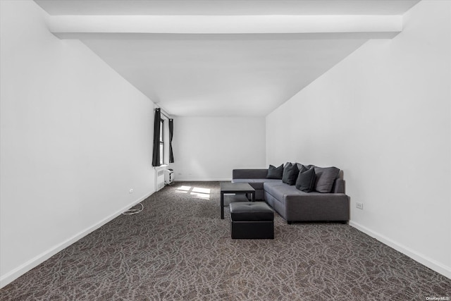 carpeted living room with radiator heating unit and beamed ceiling