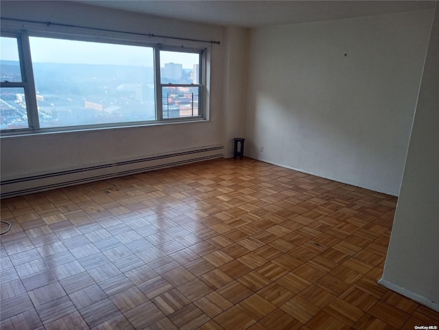 unfurnished room with baseboard heating