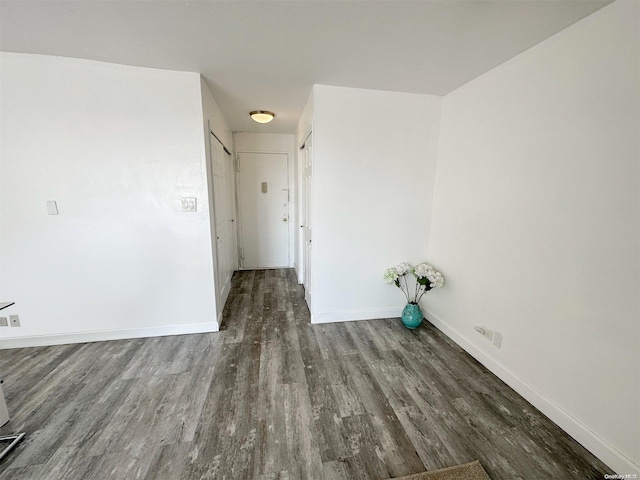 laundry area featuring dark wood-type flooring