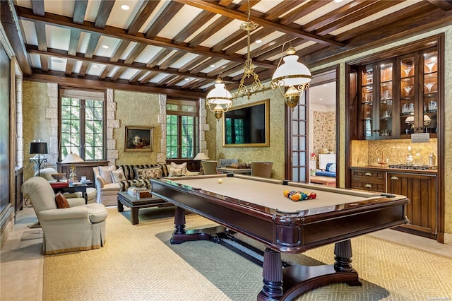 playroom featuring coffered ceiling, beam ceiling, pool table, and bar area