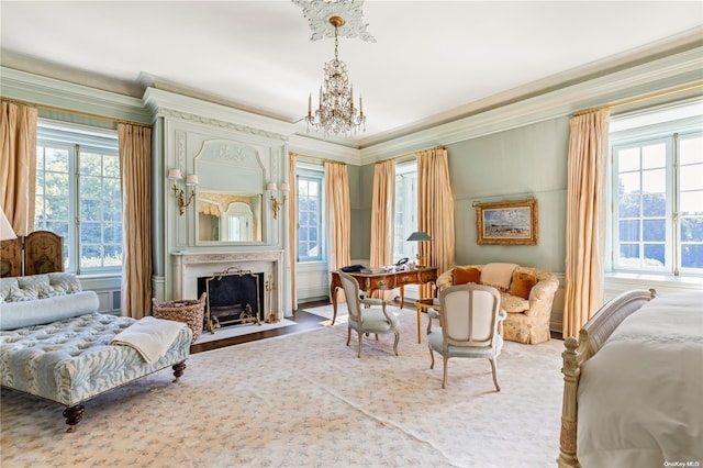 sitting room with crown molding, plenty of natural light, and wood-type flooring