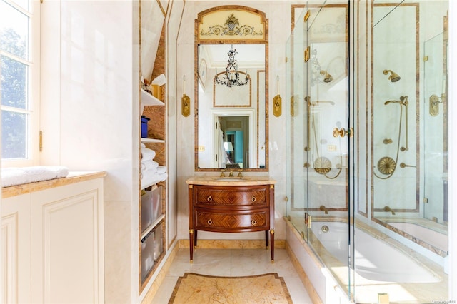 bathroom featuring combined bath / shower with glass door, vanity, and tile patterned flooring