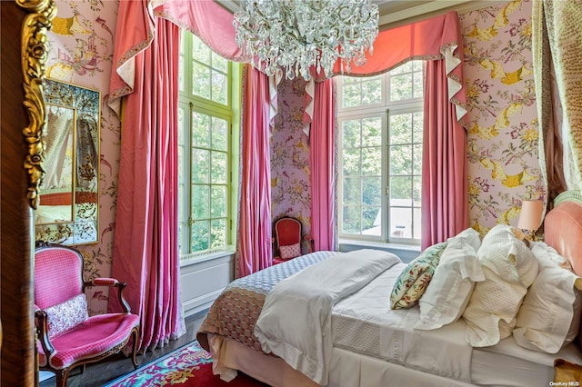 bedroom with ornamental molding, multiple windows, and a notable chandelier