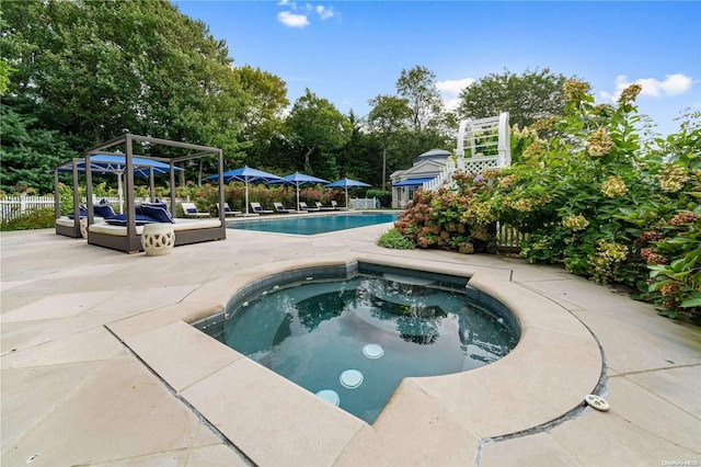 view of swimming pool with a patio area and an in ground hot tub