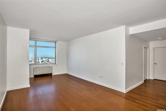 unfurnished living room featuring dark hardwood / wood-style flooring