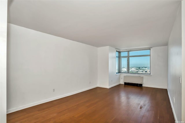 interior space featuring radiator heating unit and dark wood-type flooring