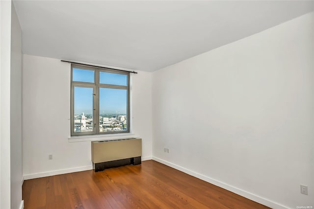 empty room with hardwood / wood-style floors