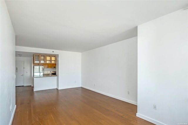 unfurnished living room featuring dark hardwood / wood-style flooring