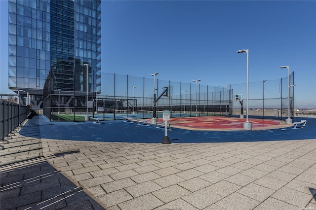 view of swimming pool with basketball court