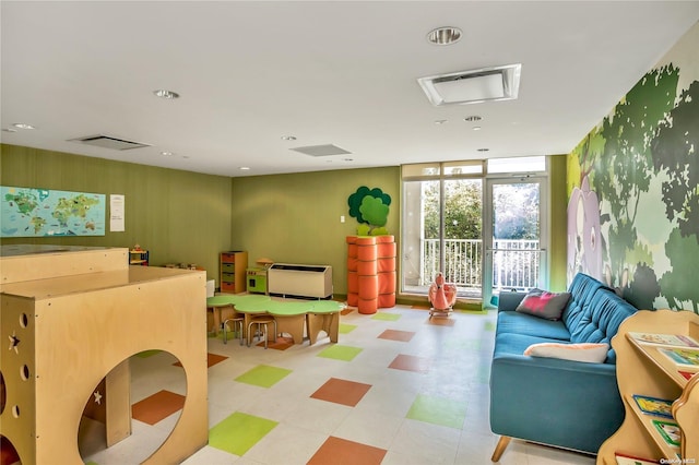 game room featuring floor to ceiling windows