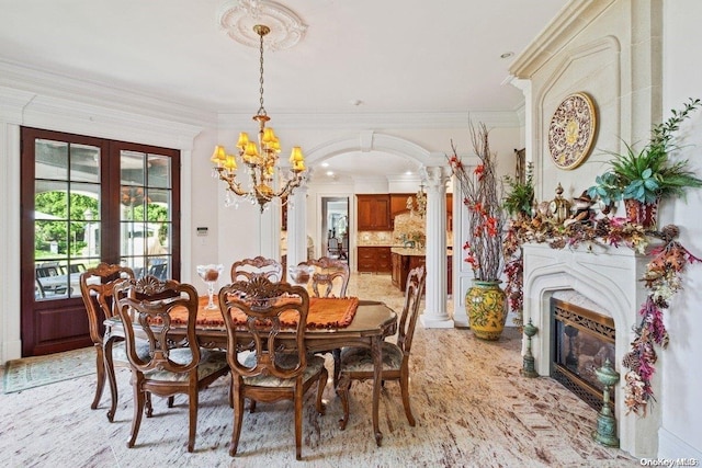 dining area featuring an inviting chandelier, crown molding, and french doors