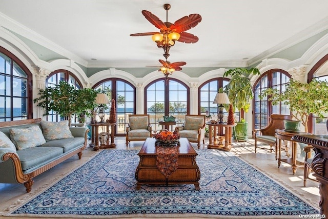 interior space with ceiling fan, a healthy amount of sunlight, and a water view