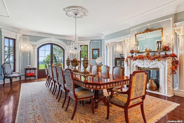 dining space featuring dark hardwood / wood-style floors, ornamental molding, and an inviting chandelier