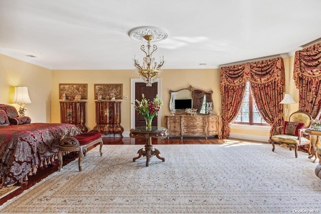 bedroom with hardwood / wood-style floors and crown molding