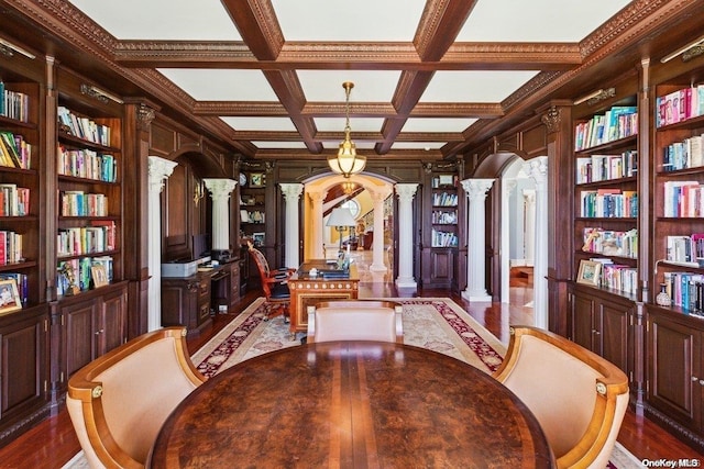 dining area with coffered ceiling, dark hardwood / wood-style floors, built in shelves, beam ceiling, and decorative columns