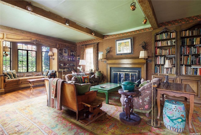 491 Muttontown Rd, Muttontown, NY 11791 - living room featuring a glass covered fireplace, beam ceiling, wood finished floors, and wallpapered walls