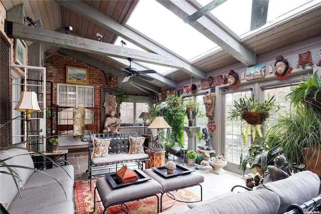 sunroom featuring a wealth of natural light, vaulted ceiling with skylight, ceiling fan, and wooden ceiling