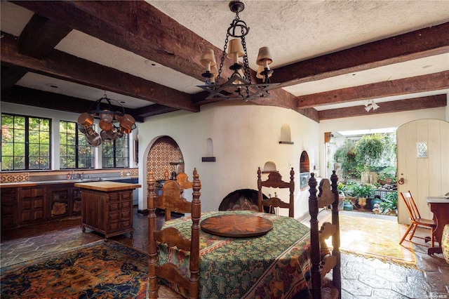 491 Muttontown Rd, Muttontown, NY 11791 - dining room with a chandelier, stone floors, beam ceiling, and arched walkways