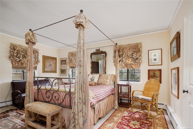 bedroom with ornamental molding and a baseboard heating unit