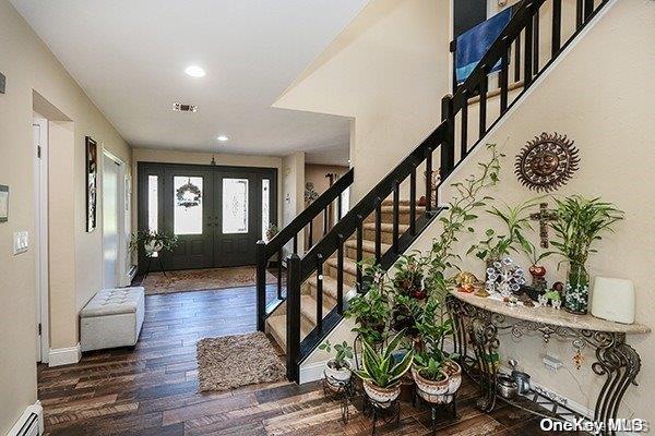 foyer entrance featuring french doors, dark hardwood / wood-style flooring, and baseboard heating