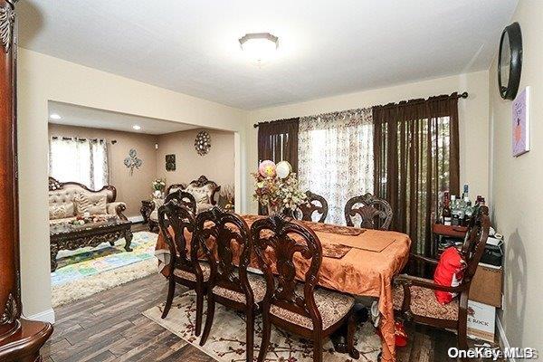 dining space with dark hardwood / wood-style floors