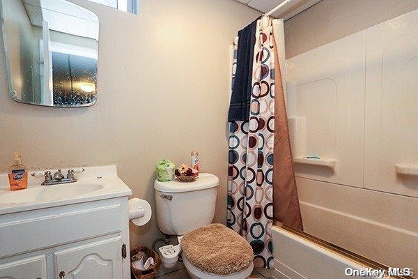 full bathroom featuring vanity, toilet, and shower / bath combo with shower curtain