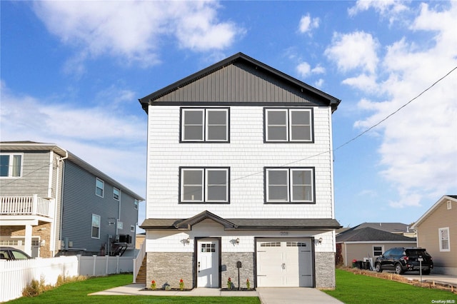 view of front facade with a garage and a front lawn