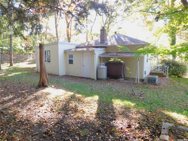 back of property featuring central AC