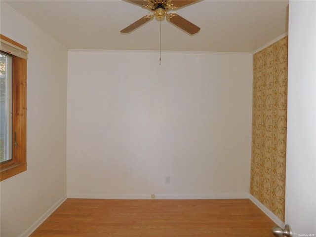 empty room with ceiling fan, light hardwood / wood-style flooring, and ornamental molding