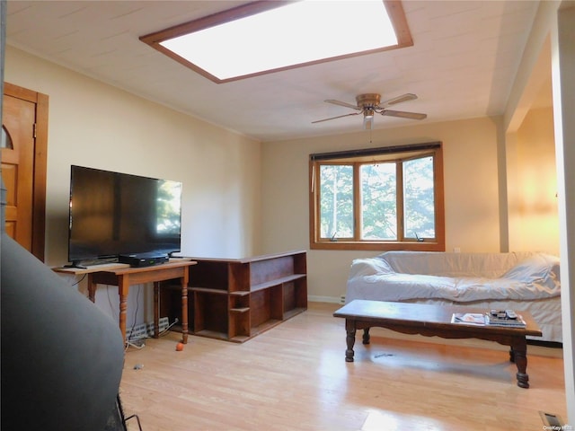 living room with ceiling fan and light hardwood / wood-style flooring