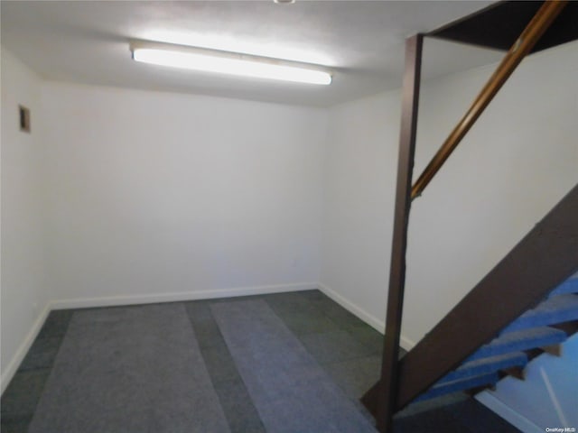 basement with dark colored carpet