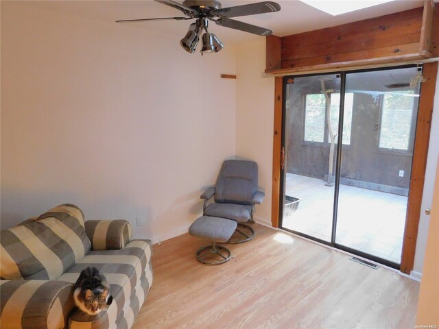 living area featuring ceiling fan and light hardwood / wood-style flooring