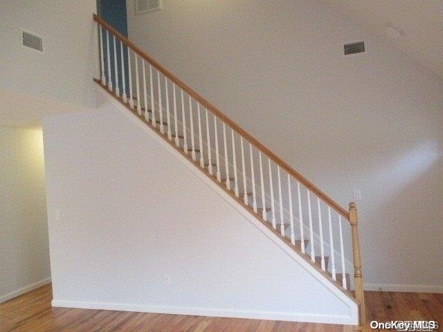 stairs with hardwood / wood-style flooring