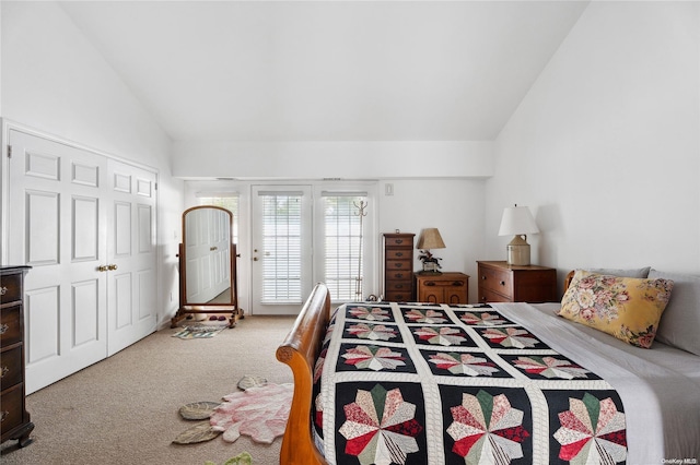 carpeted bedroom with a closet and vaulted ceiling