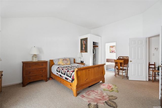 bedroom featuring light carpet and vaulted ceiling