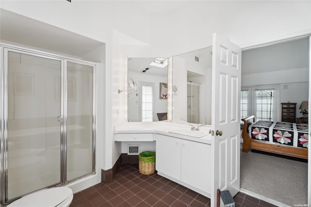 bathroom featuring tile patterned flooring, vanity, toilet, and an enclosed shower