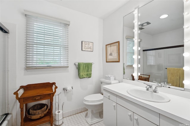 bathroom with tile patterned flooring, vanity, a shower with shower door, and toilet