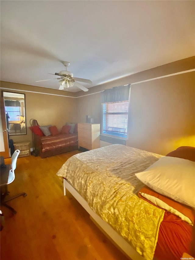 bedroom featuring hardwood / wood-style floors and ceiling fan