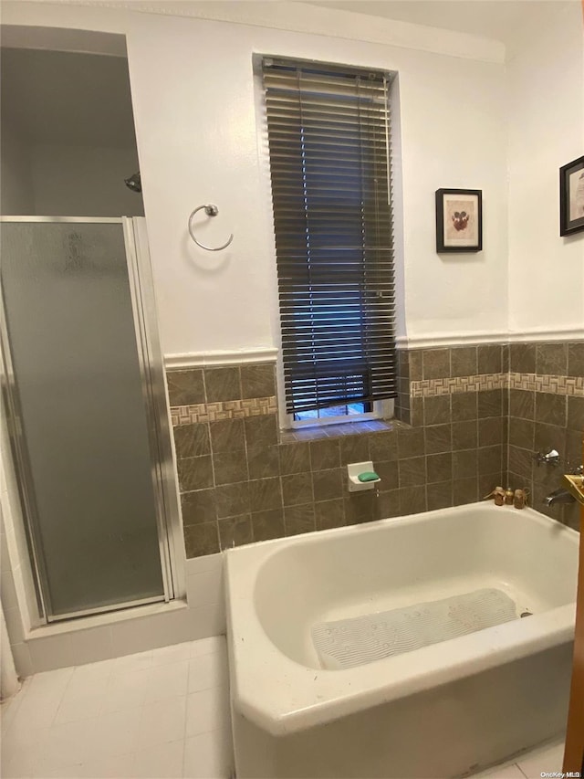 bathroom featuring independent shower and bath and tile walls