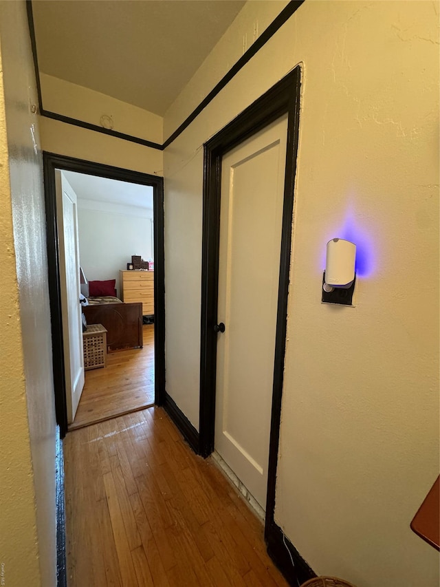 corridor with hardwood / wood-style floors