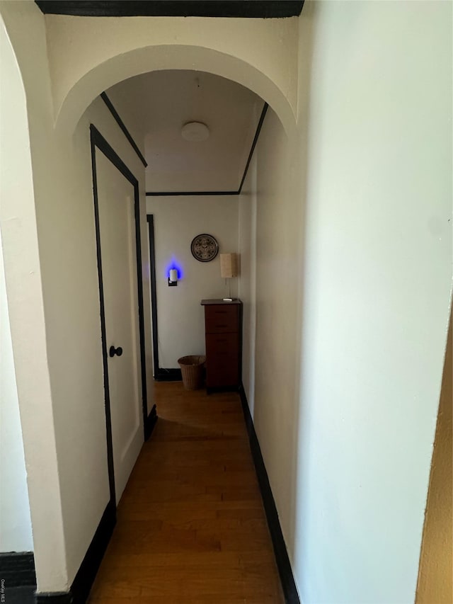 hallway with hardwood / wood-style flooring