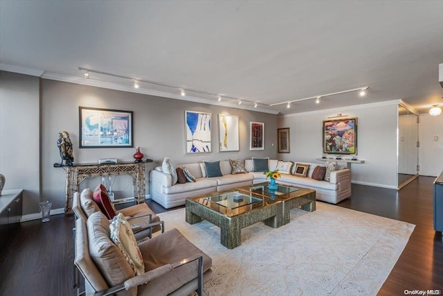 living room featuring crown molding, rail lighting, and dark hardwood / wood-style floors