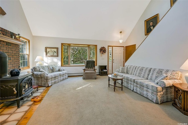 living room with a baseboard radiator, a wood stove, and lofted ceiling